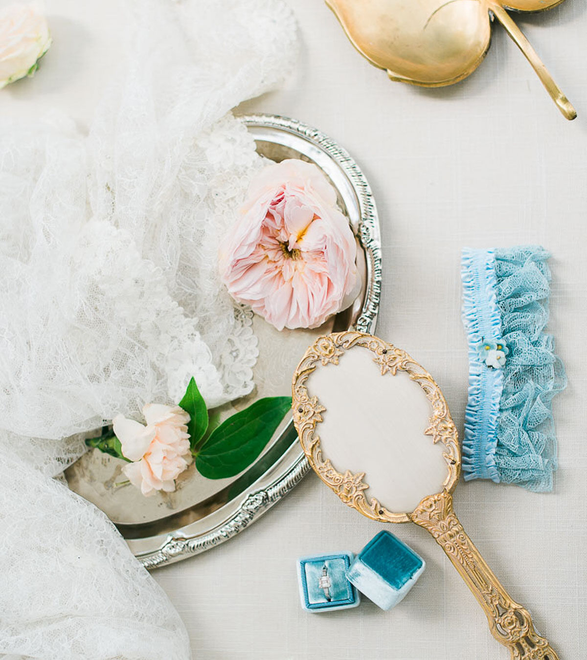 10 questions you should ask your wedding photographer, mirror and garter with lace and florals flat lay