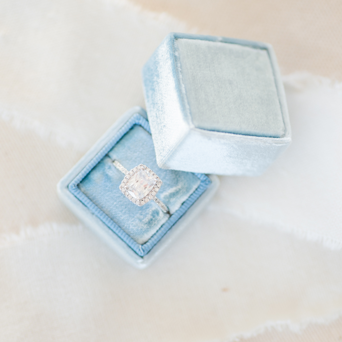 Blue Velvet ring box with gorgeous cushion cut diamond with halo